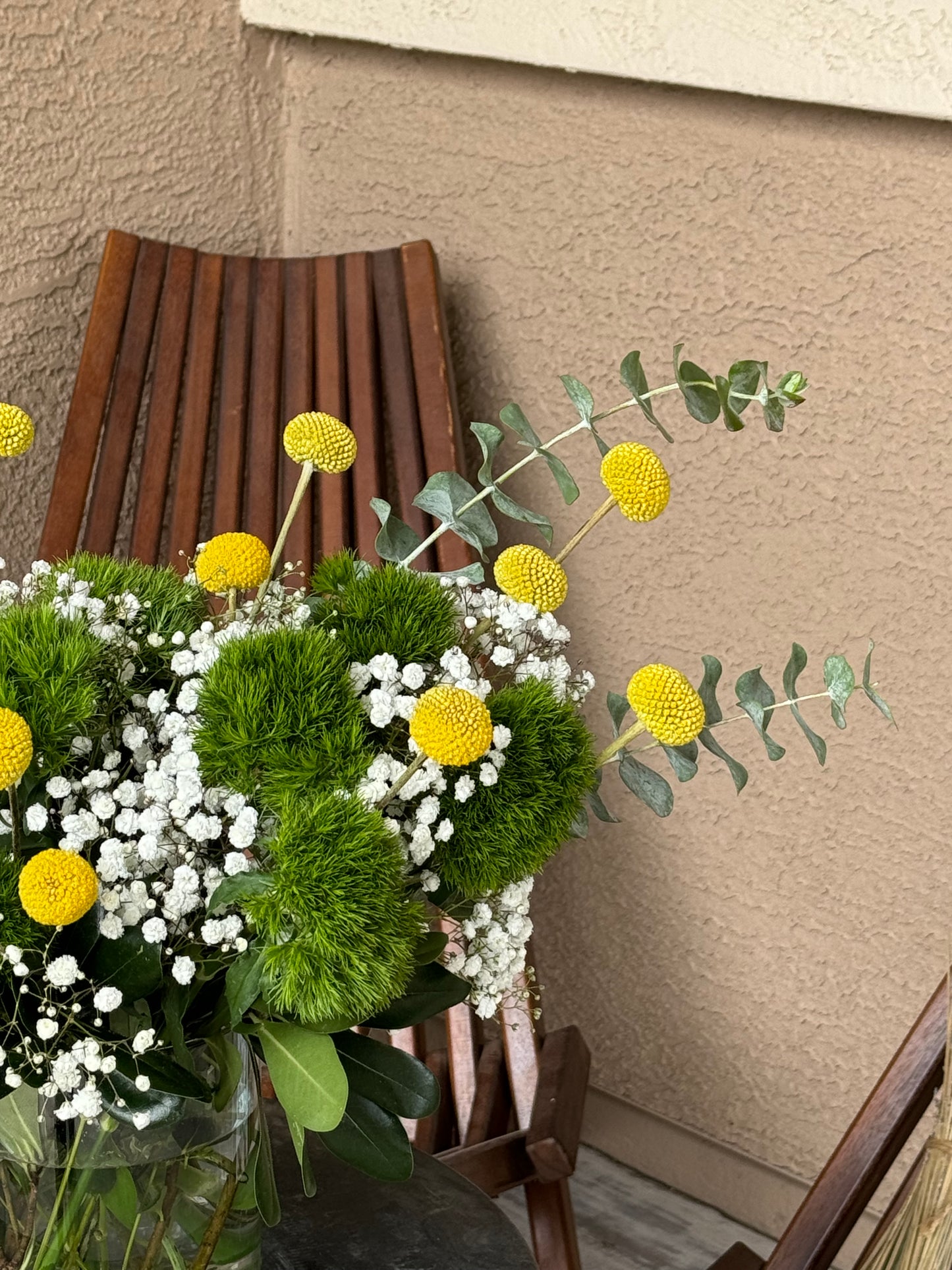 Vibrant First Day Bouquet featuring textured dianthus and sunny billy yellow balls. Available in deluxe and premium sizes. Perfect for brightening any space or gifting.