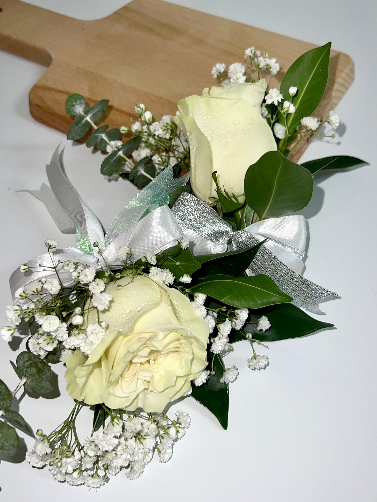 Order wrist corsage and boutonnière for prom dance. Classic wedding boutonnière featuring one rose.