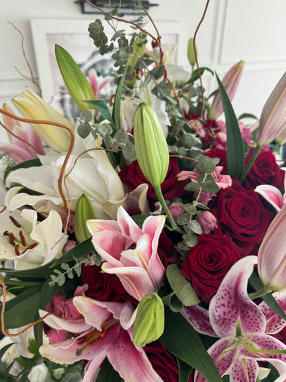 Bouquet of red roses, pink lilies, and white flowers with greenery for same day flower delivery in Gilbert, AZ