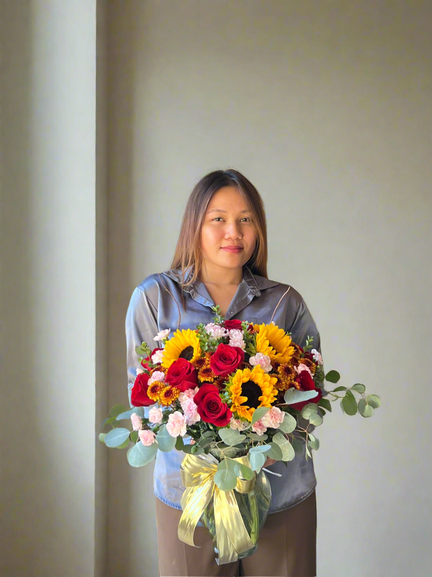 Autumn vase with warm earthy tones, seasonal blooms, and fall inspired foliage.
