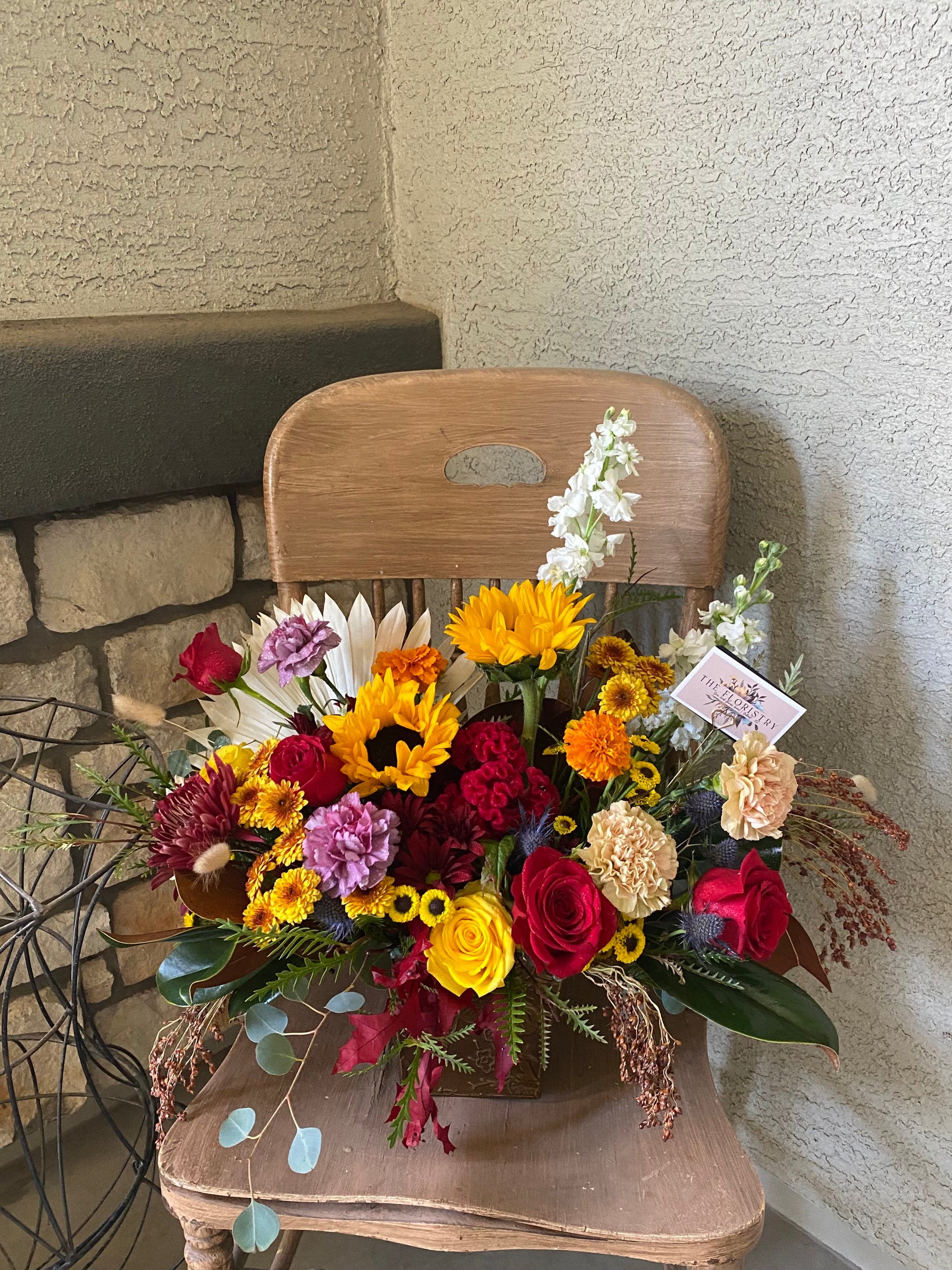 Autumn bouquet with warm earthy tones, seasonal blooms, and fall-inspired foliage.
