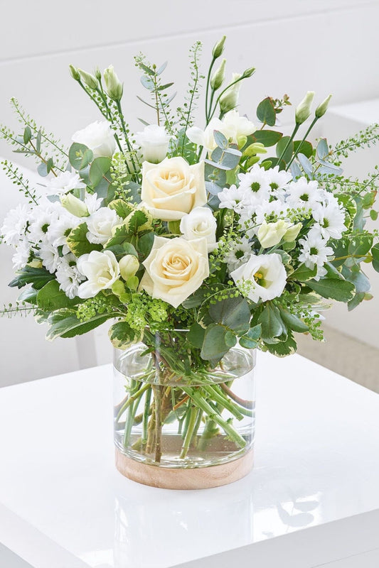 This timeless floral display is suitable for those who prefer clean fresh colours. An array of seasonal white and green flowers complimented with lush tropical greenery makes for an elegant yet simple floral display.

Suitable for birthdays, anniversaries, sympathy or get well hospital flowers

Please NOTE: flower content will vary from the photo from season to season