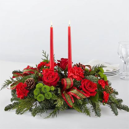 Festive green and red holiday candle centerpiece with fresh evergreens, red blooms, and seasonal accents. available for same day delivery in Gilbert, Queen Creek, Chandler, Mesa, Tempe, Phoenix Arizona