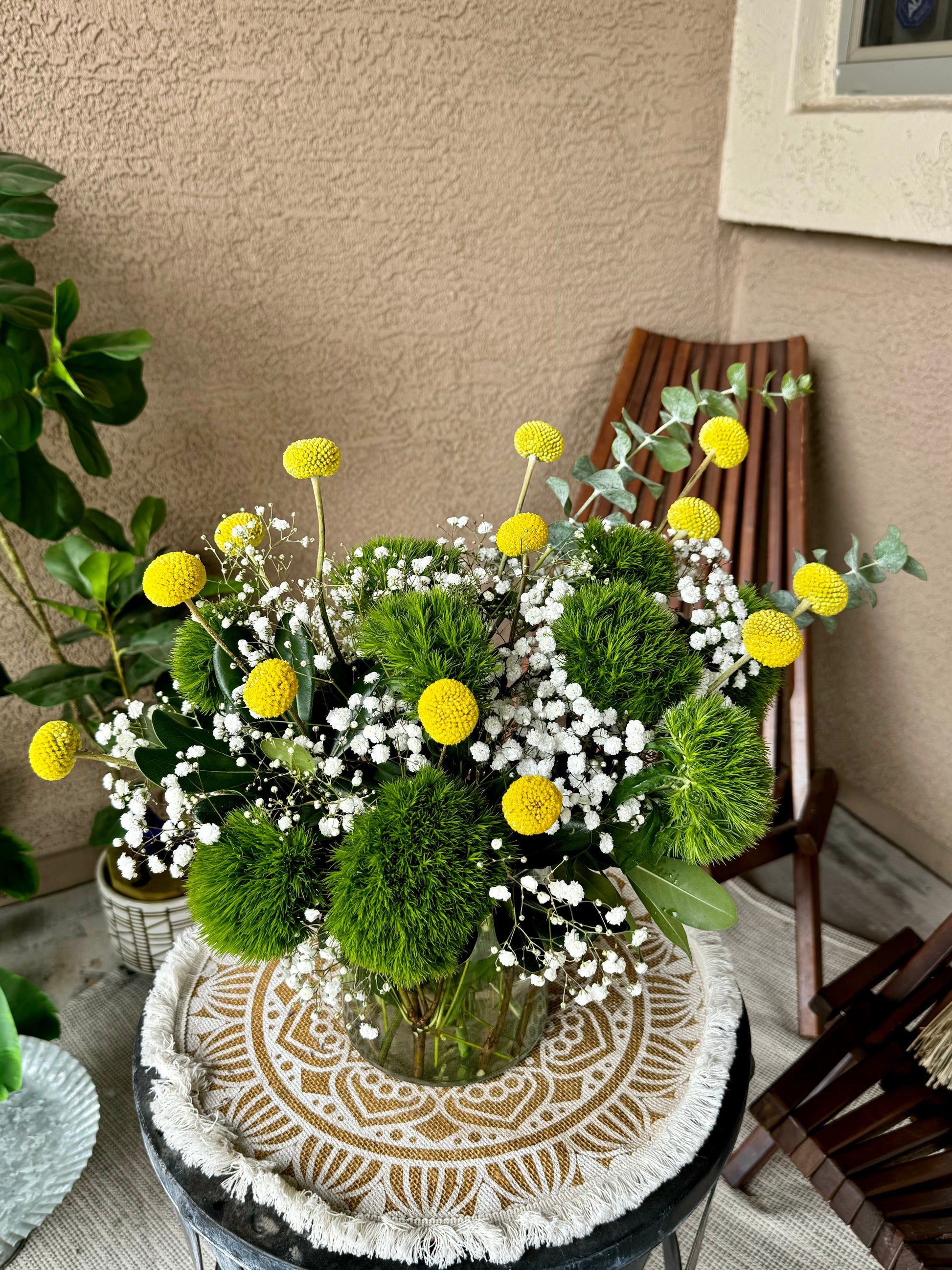 Vibrant First Day Bouquet featuring textured dianthus and sunny billy yellow balls. Available in deluxe and premium sizes. Perfect for brightening any space or gifting.