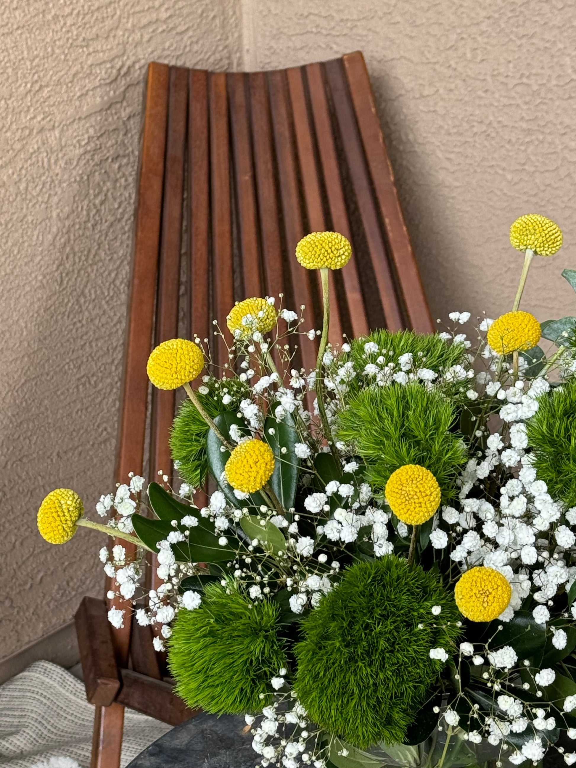 Vibrant First Day Bouquet featuring textured dianthus and sunny billy yellow balls. Available in deluxe and premium sizes. Perfect for brightening any space or gifting.
