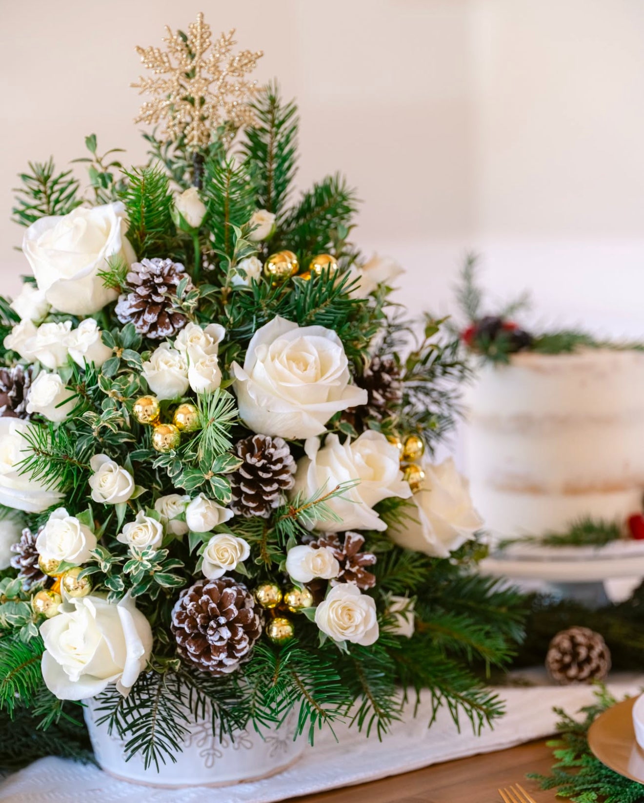 Snowy Oasis Tree with white roses and holiday greens arranged, available for same day flowers delivery in Gilbert, Arizona,