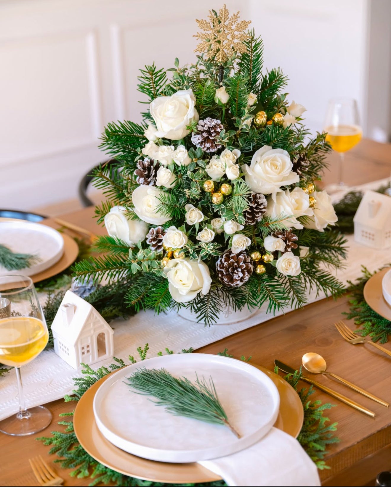 Luxury Christmas floral tree featuring white roses, seasonal blooms, and festive greens Woody centerpiece.