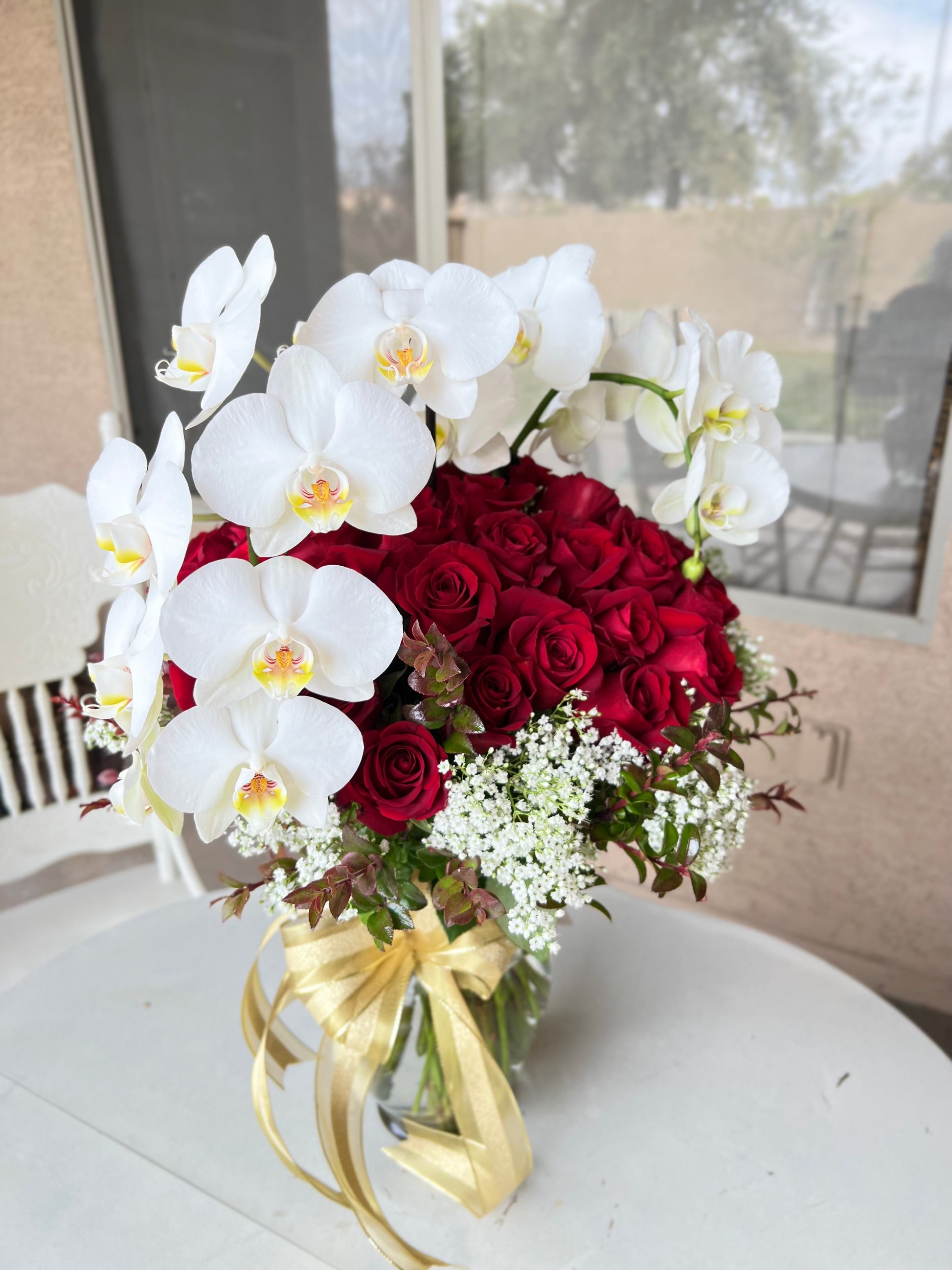Luxury White Orchids symbolize purity, sophistication, paired with Premium Red Roses exude love and romance. Designed to impress, perfect for anniversaries, or moments when only the finest will do. 