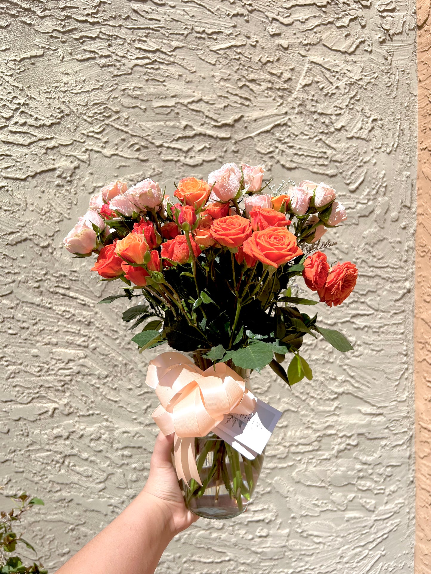 Romantic pink spray roses bouquet in vase, perfect for celebrations or heartfelt gestures.