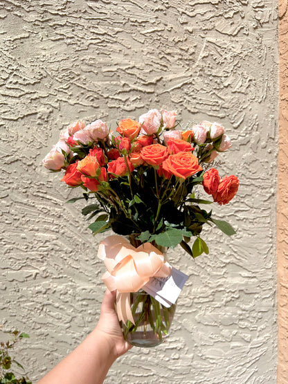 Romantic pink spray roses bouquet in vase, perfect for celebrations or heartfelt gestures.