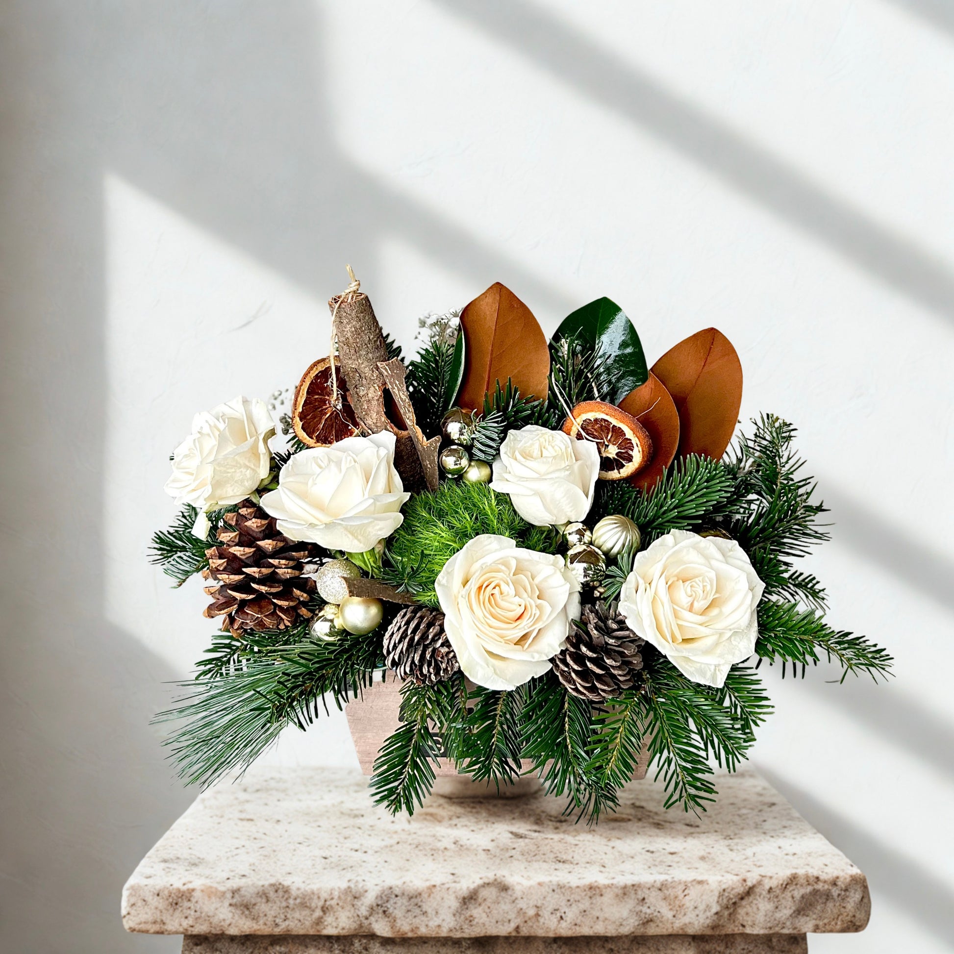 A festive Christmas flower arrangement with a white snowy theme delivered in Mesa az