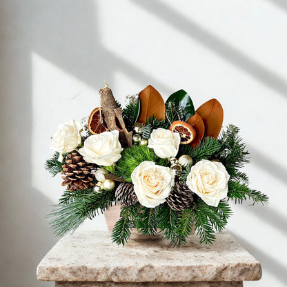 A festive Christmas flower arrangement with a white snowy theme delivered in Mesa az
