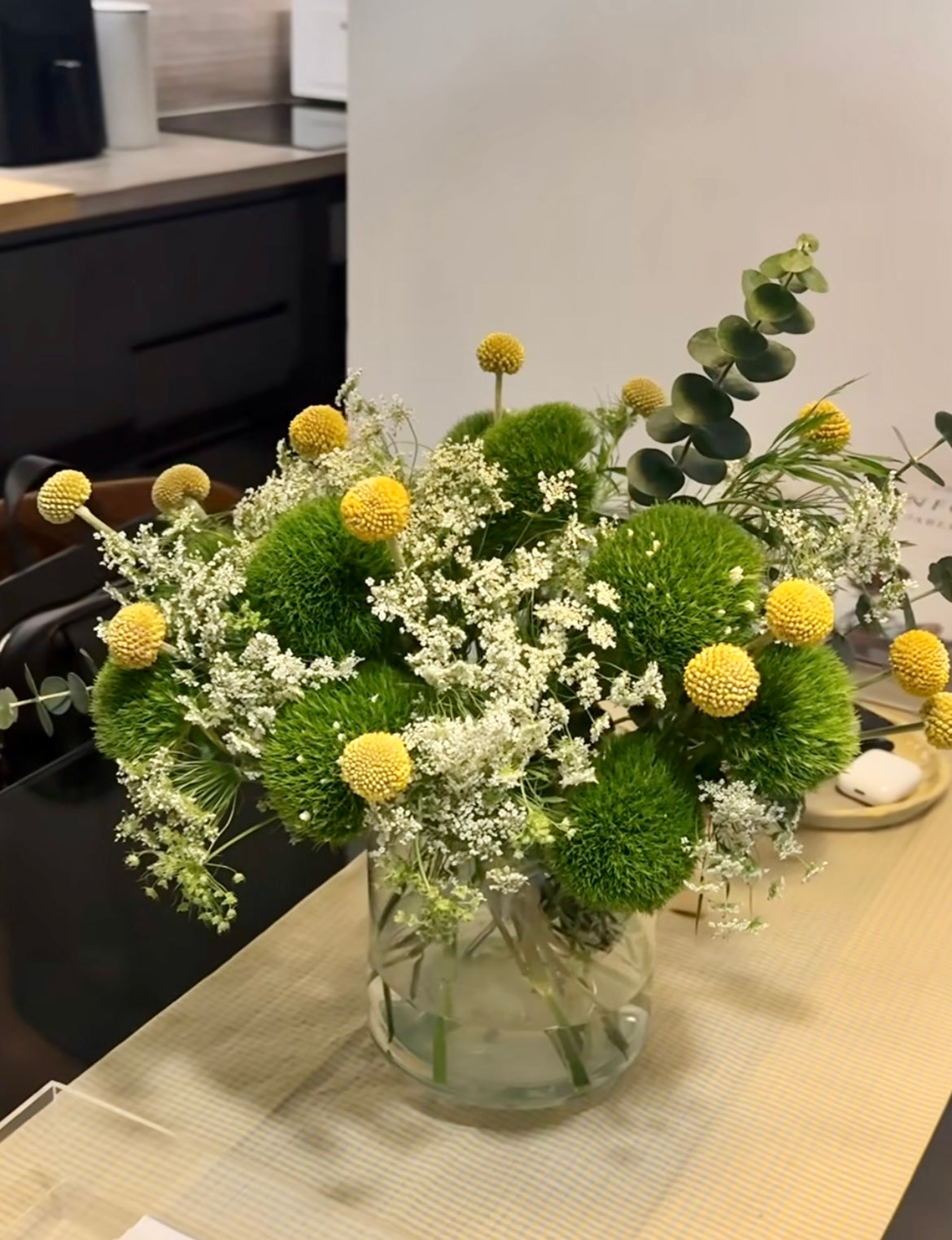 Vibrant First Day Bouquet featuring textured dianthus and sunny billy yellow balls. Available in deluxe and premium sizes. Perfect for brightening any space or gifting.
