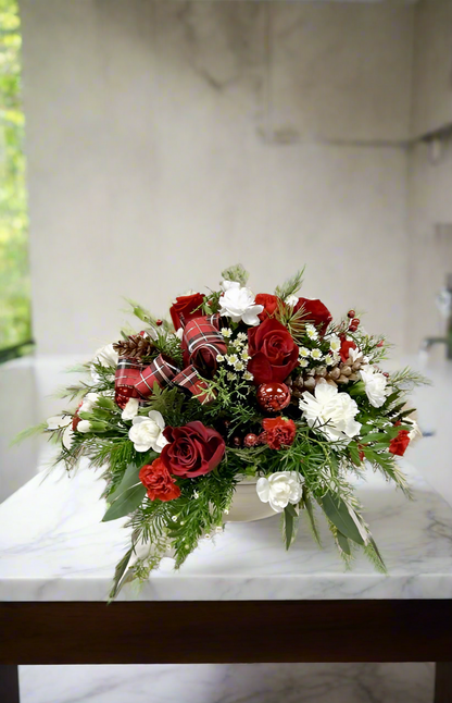 Mid size holiday centerpiece with fresh greenery, pinecones, berries, and apples in a red container. Perfect for festive tables or seasonal décor.
