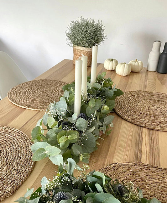 Fresh silver dollar eucalyptus centerpiece with soft cascading greenery for table décor.
