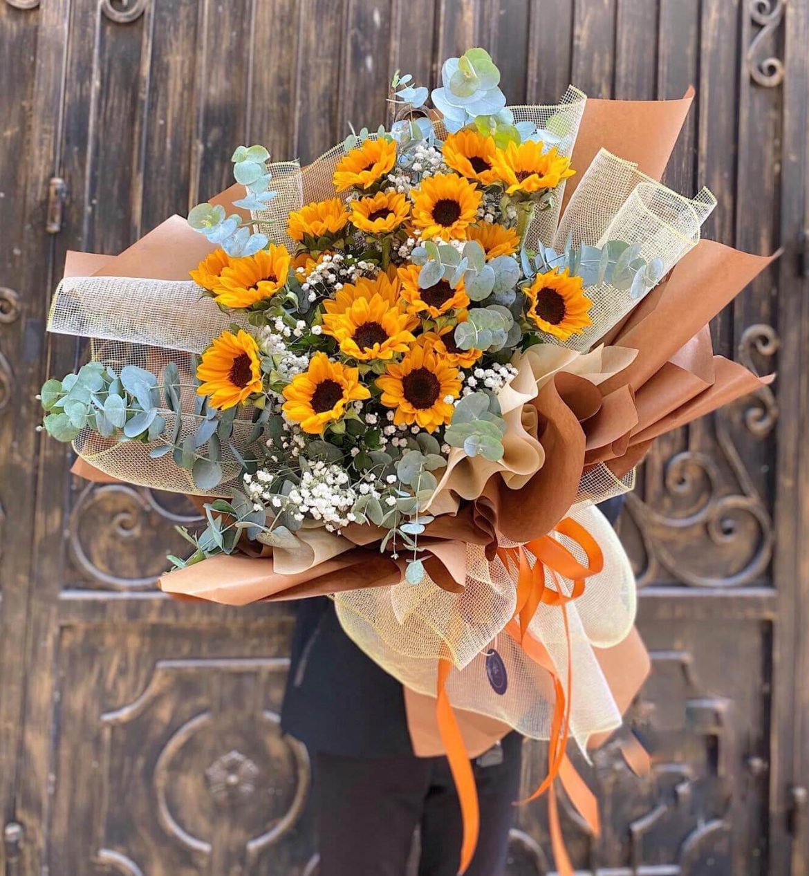 Bright sunflower bouquet wrapped in kraft paper for a cheerful gift.
